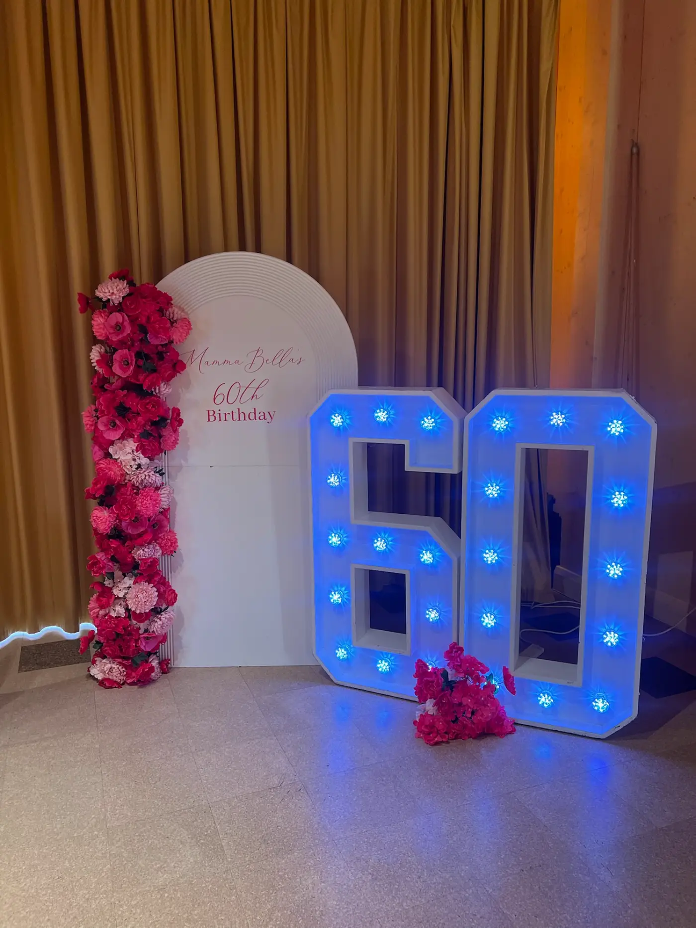 Fuchsia and blush 60th birthday room with illuminated marquee 60