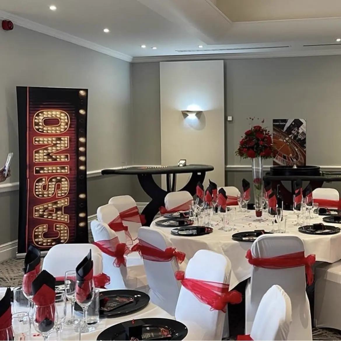 Casino-themed room with marquee CASINO sign and balloon arch