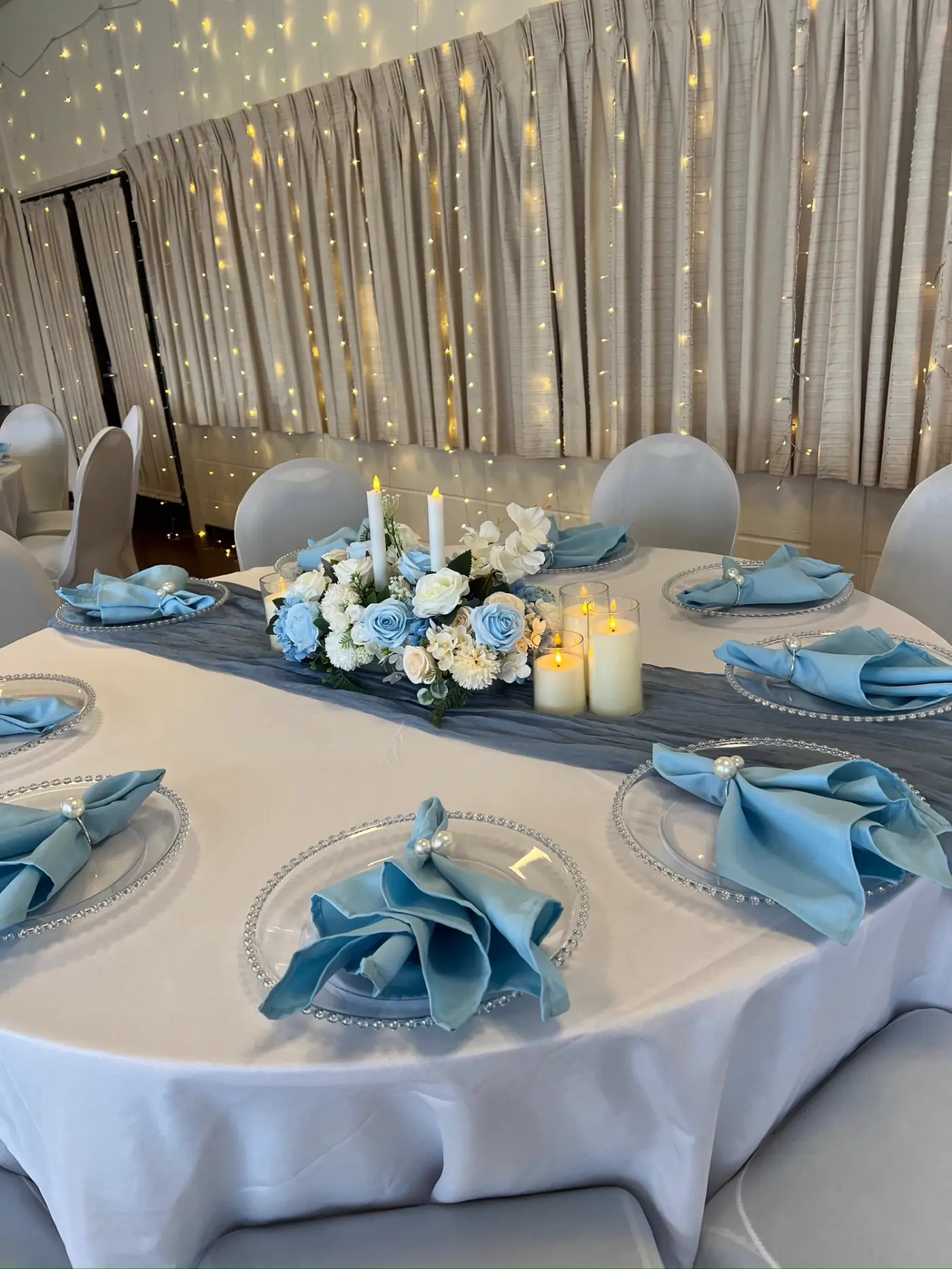 Round table with beaded chargers and pearl-tied napkins